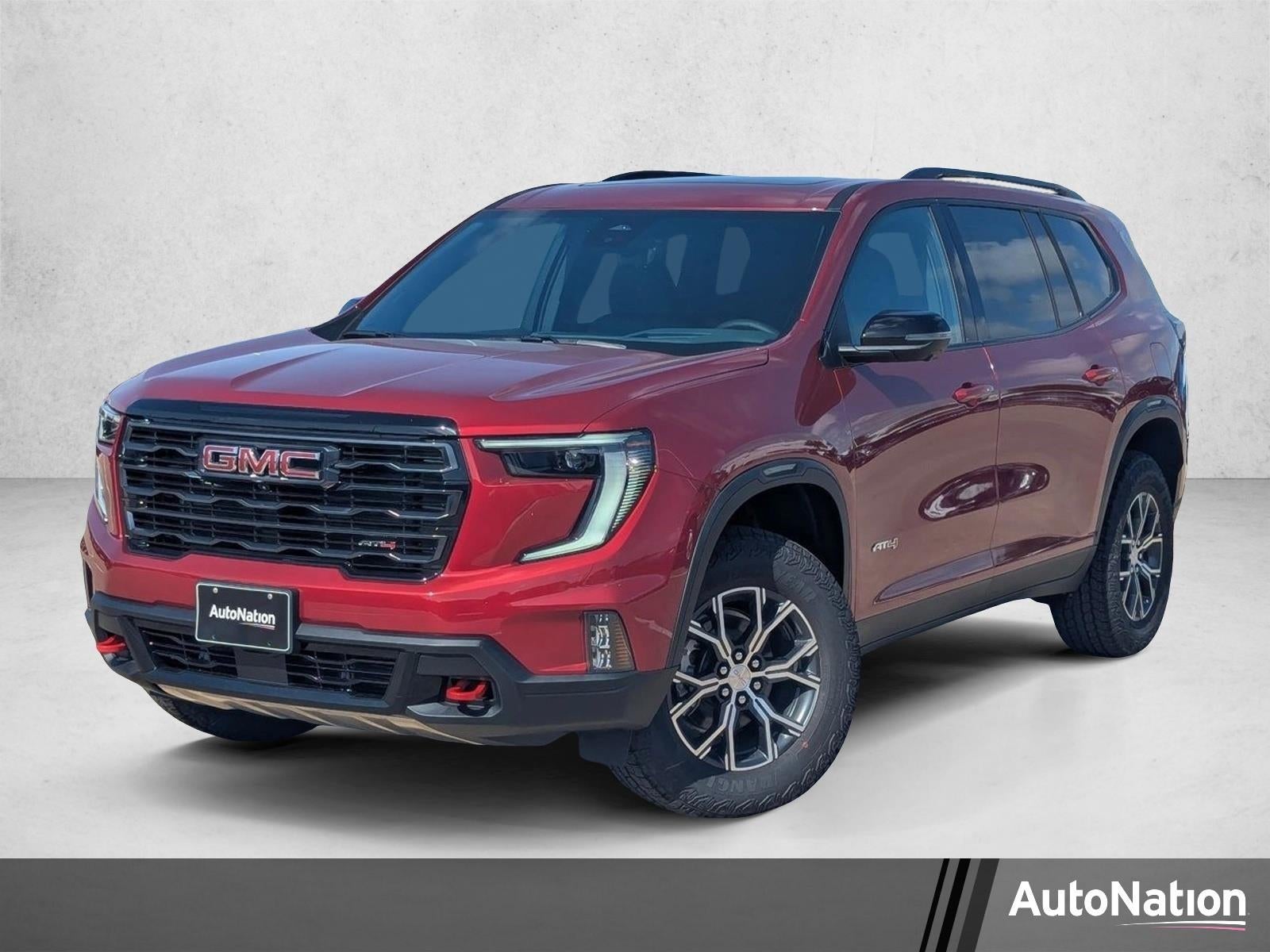 2026 GMC Acadia AT4 in Volcanic Red Tintcoat — front three-quarter view