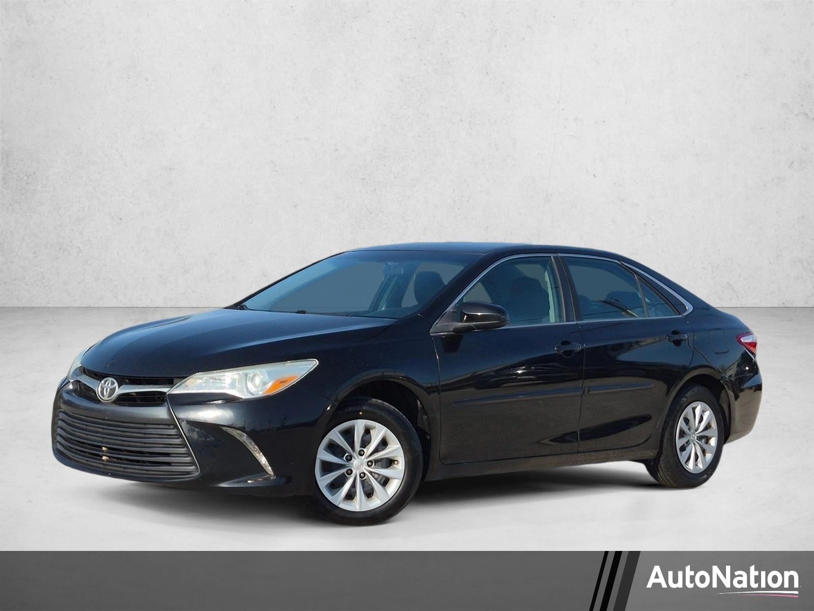 2016 Toyota Camry 4dr Sdn I4 Auto LE (SE) in Midnight Black Metallic — front three-quarter view